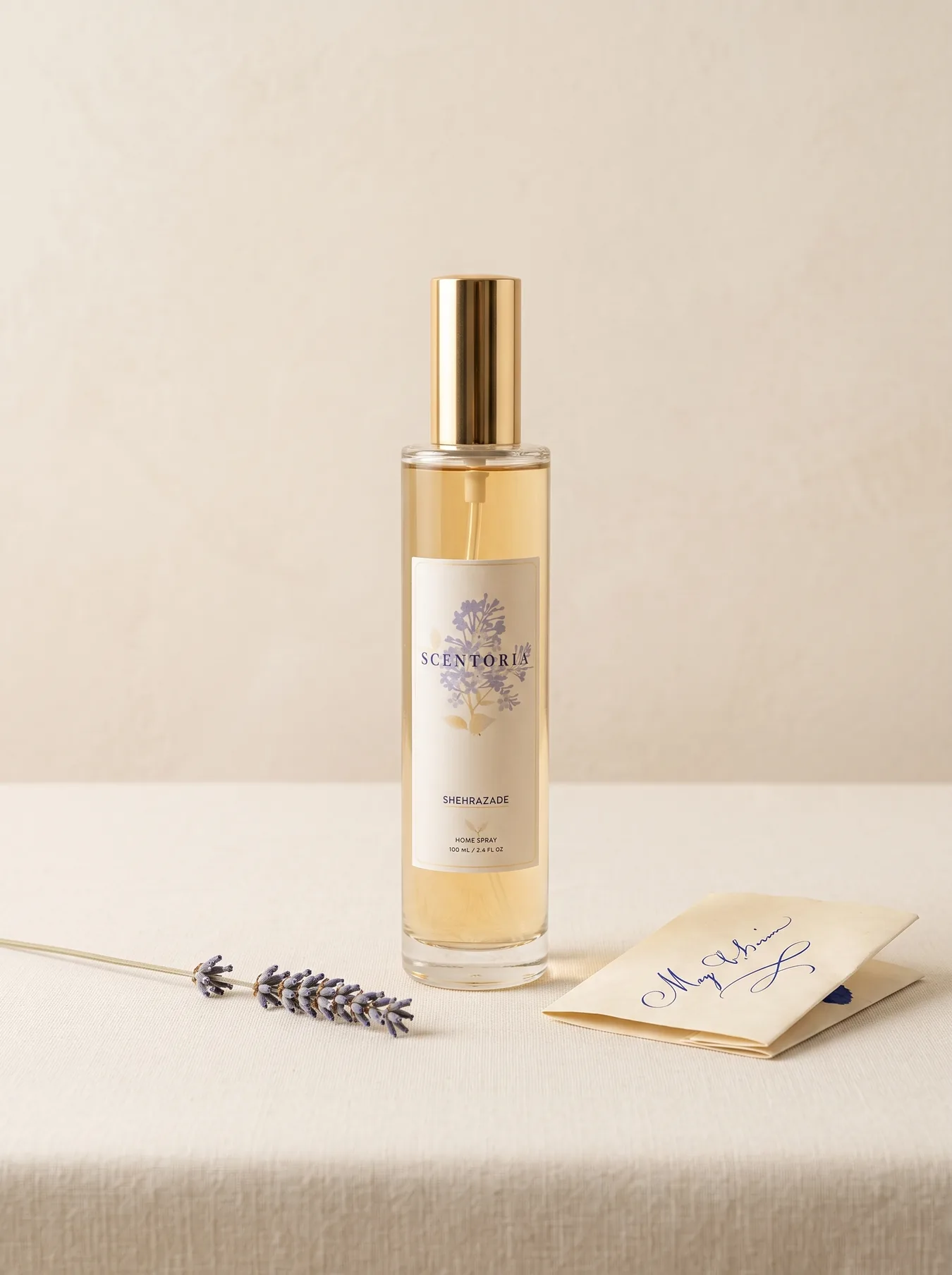 The Shehrazade home spray on a cream linen sill with dried lavender and a handwritten note